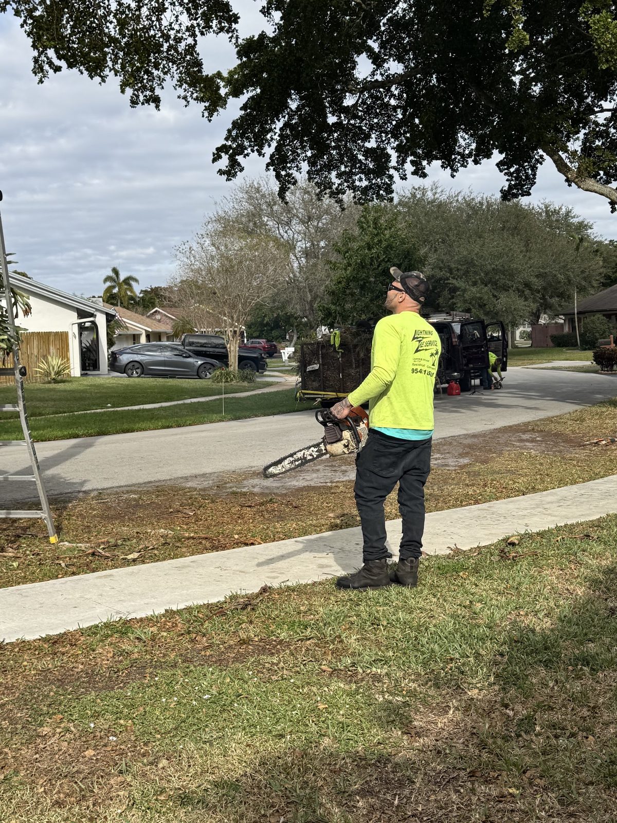 Crew member heading up with the chainsaw